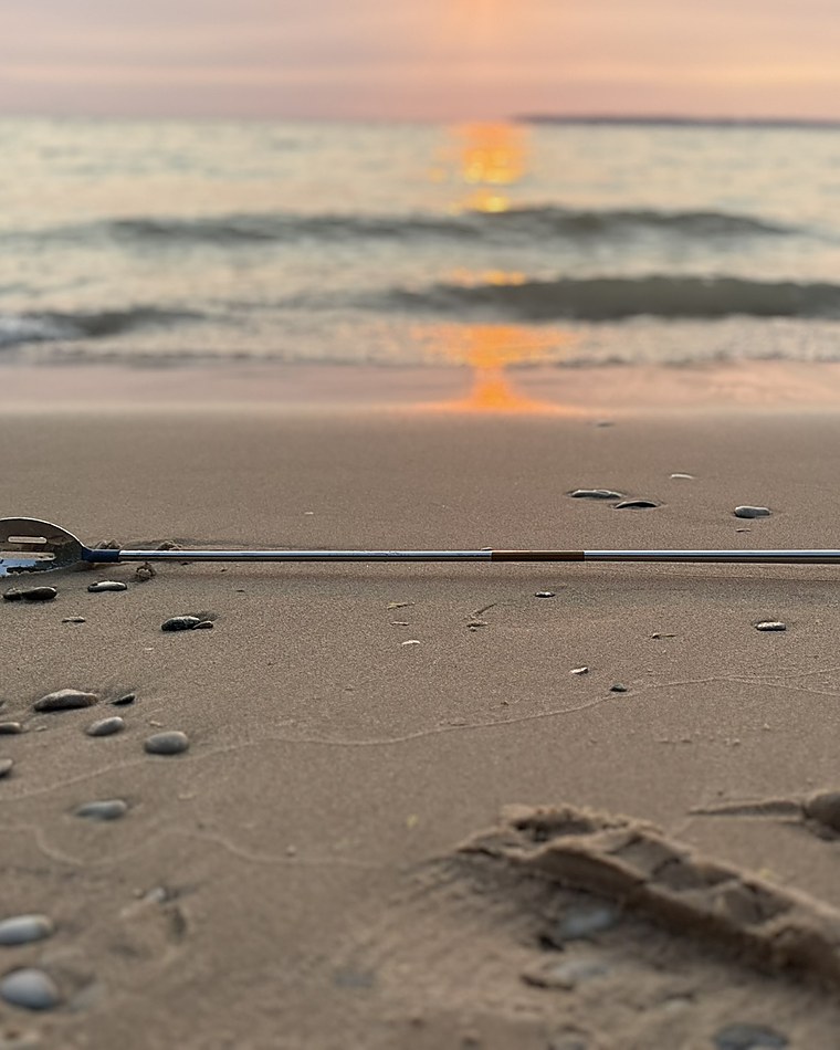 the berk laid on wet sand at sunset